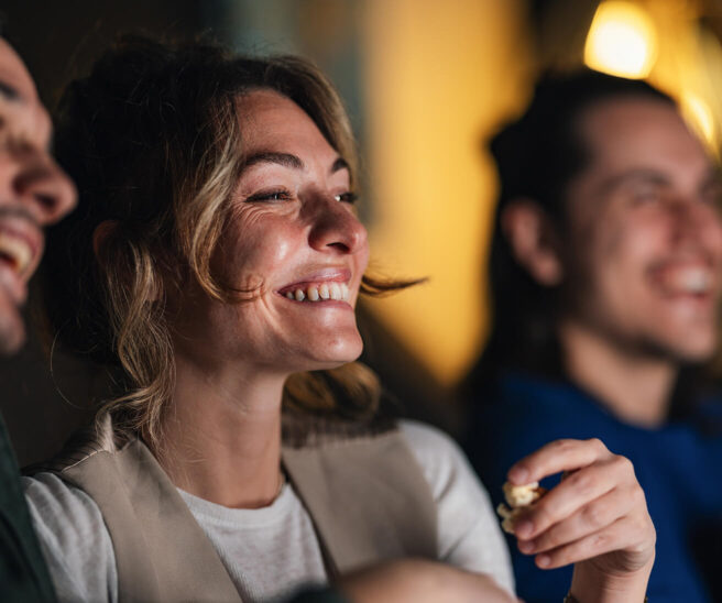 Laughing friends in a cinema